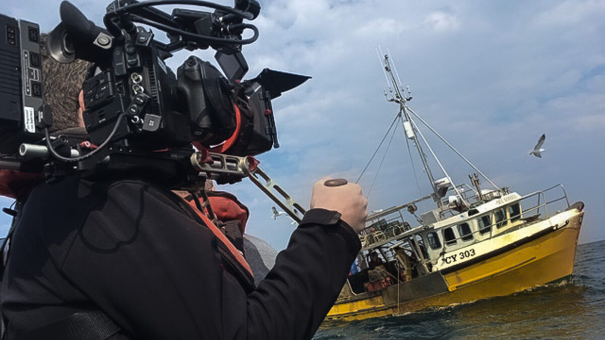 Filming on a boat in the middle of the sea.