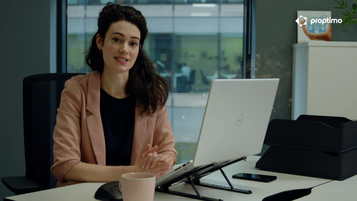 Screen grab from Proptimo corporate advert - woman sat at a laptop
