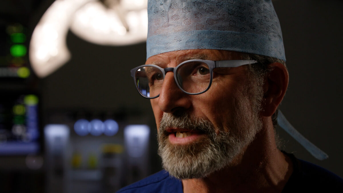 Close-up of Gordon Mackay interview in an operating theatre.