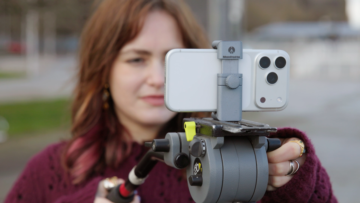 Girl filming with an iPhone on a tripod