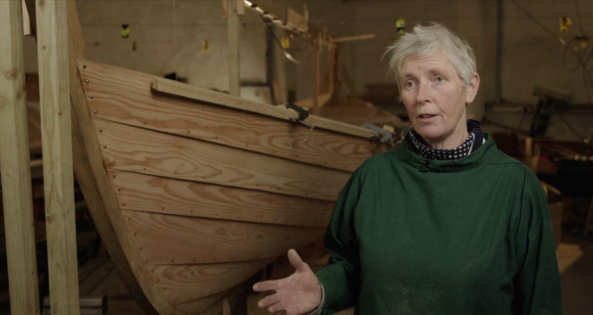 Boat Builder Gale in front of the St Ayles Skiff Tribute in Whithorn, Scotland.